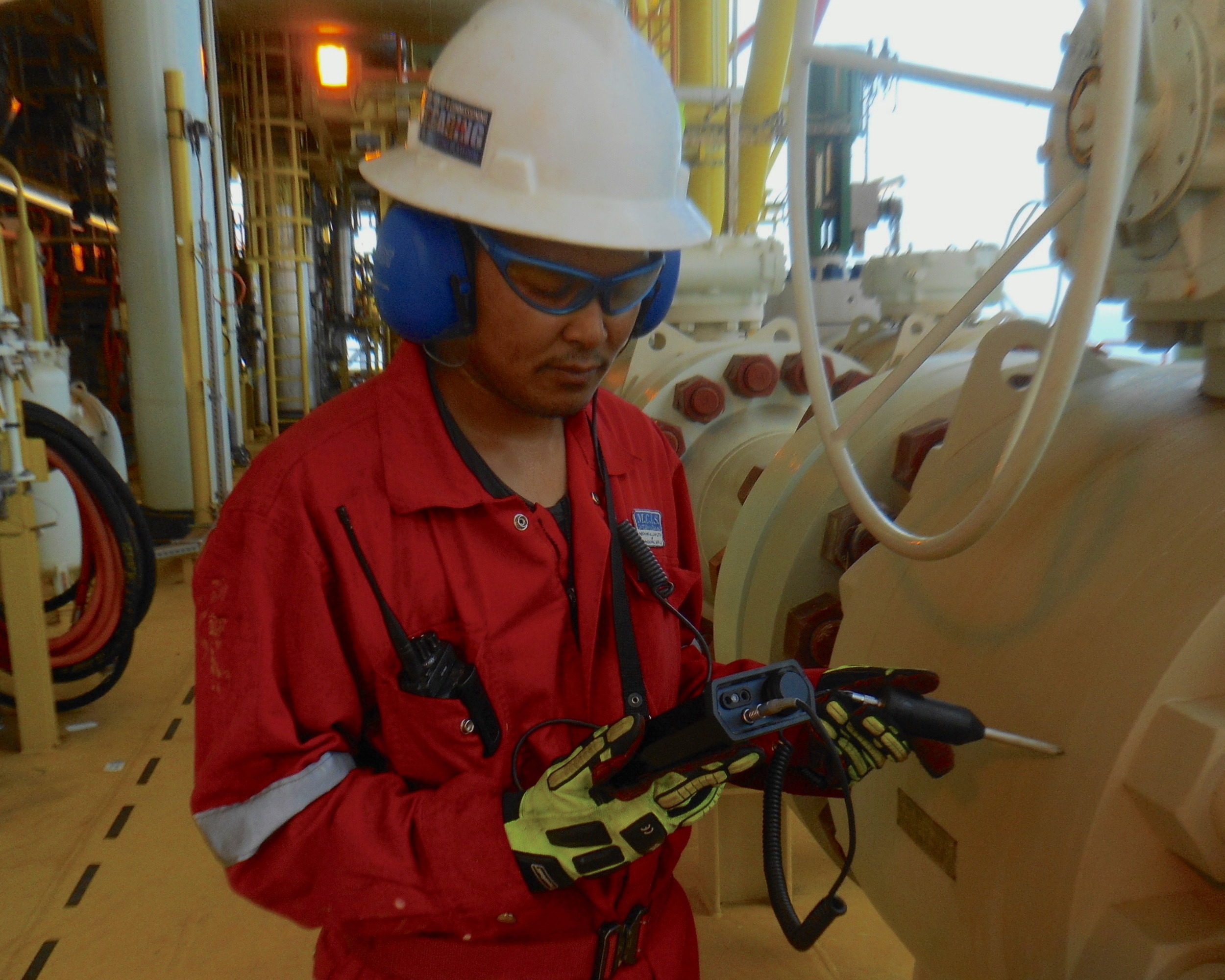 An oil and gas maintenance engineer testing for leaks