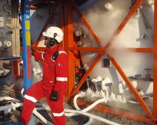 An oil & gas engineer performing n2 leak testing on an oil rig