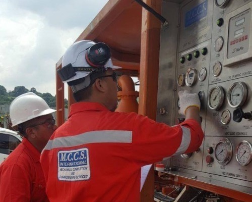 2 engineers checking gauges during a helium leak test on an offshore oil & gas platform